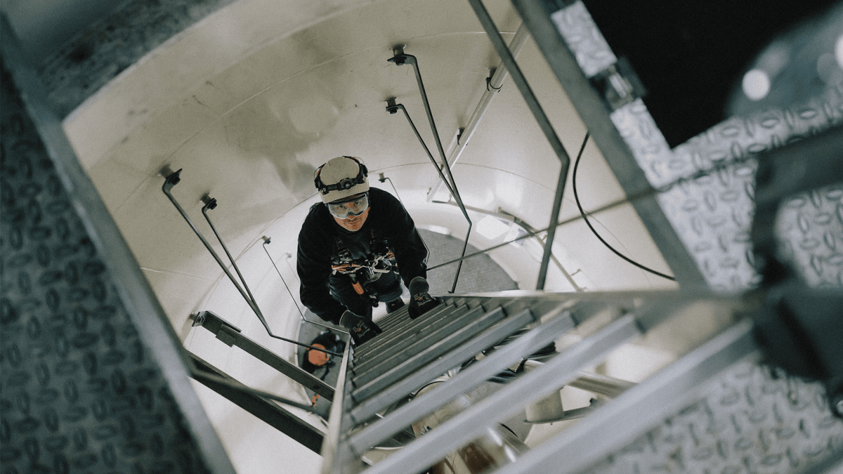 Service Technician climbing up the wind turbine